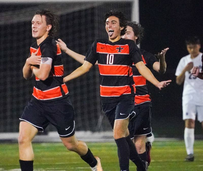 St. Charles East's Giuseppe Avendano (10) and Griffin Counts (left) celebrate after scoring a goal against West Chicago during a class 3A sectional semifinal soccer match at West Chicago High School on Wednesday, Oct. 25, 2023.