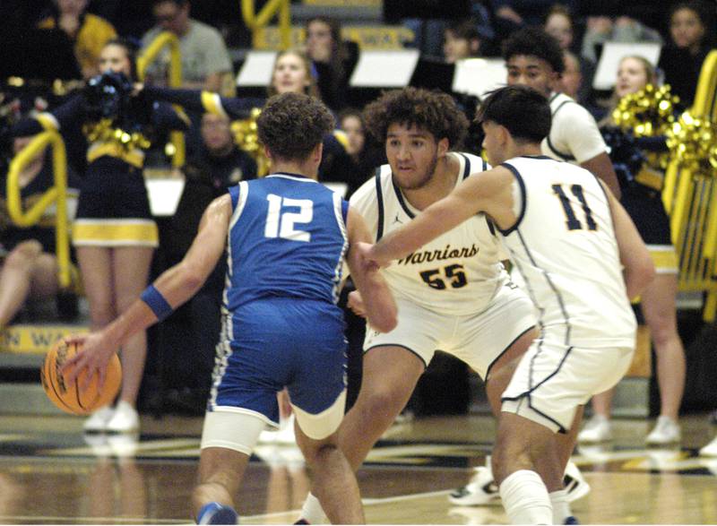 Sterling defenders AJ Coleman and Nico Battaglia block Quincy's Bradley Longcor. The action took place on Friday, December 13th at Sterling.