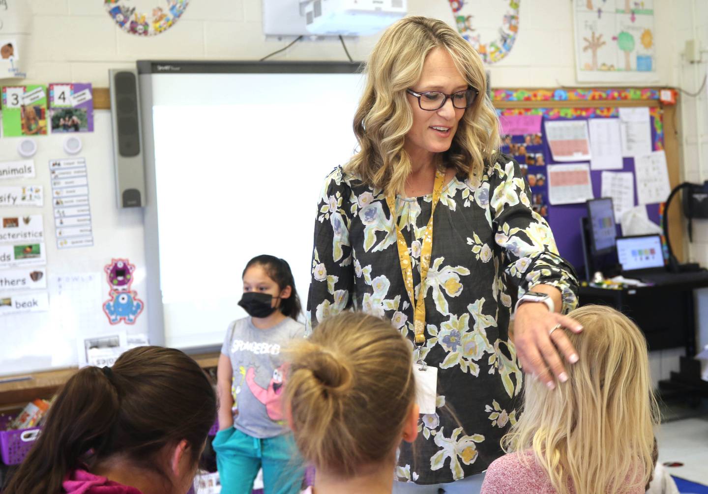 Tracy Paszotta, a kindergarten teacher at Littlejohn Elementary School, welcomes her students back from spring break the morning of Monday, March 28, 2022, at the school in DeKalb.