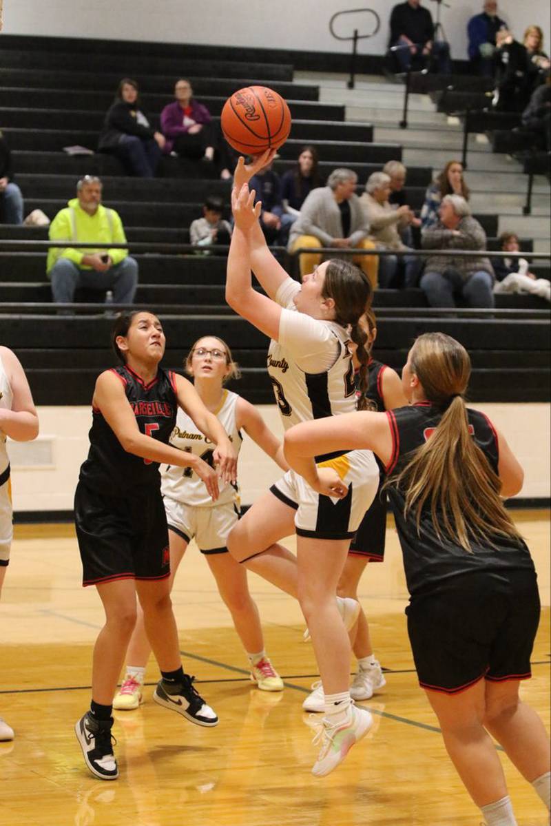 PC's Murphy Hopkins fights through traffic for a shot in Tuesday's Putnam County 8th grade night. The Pumas beat Marseilles 51-15.