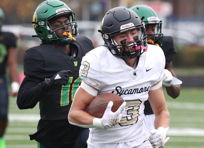 Sycamore's Carter York scores a touchdown with the Westinghouse defense in pursuit Saturday, Nov. 9, 2024 during their Class 5A second-round playoff game at Knute Rockne Stadium in Chicago.