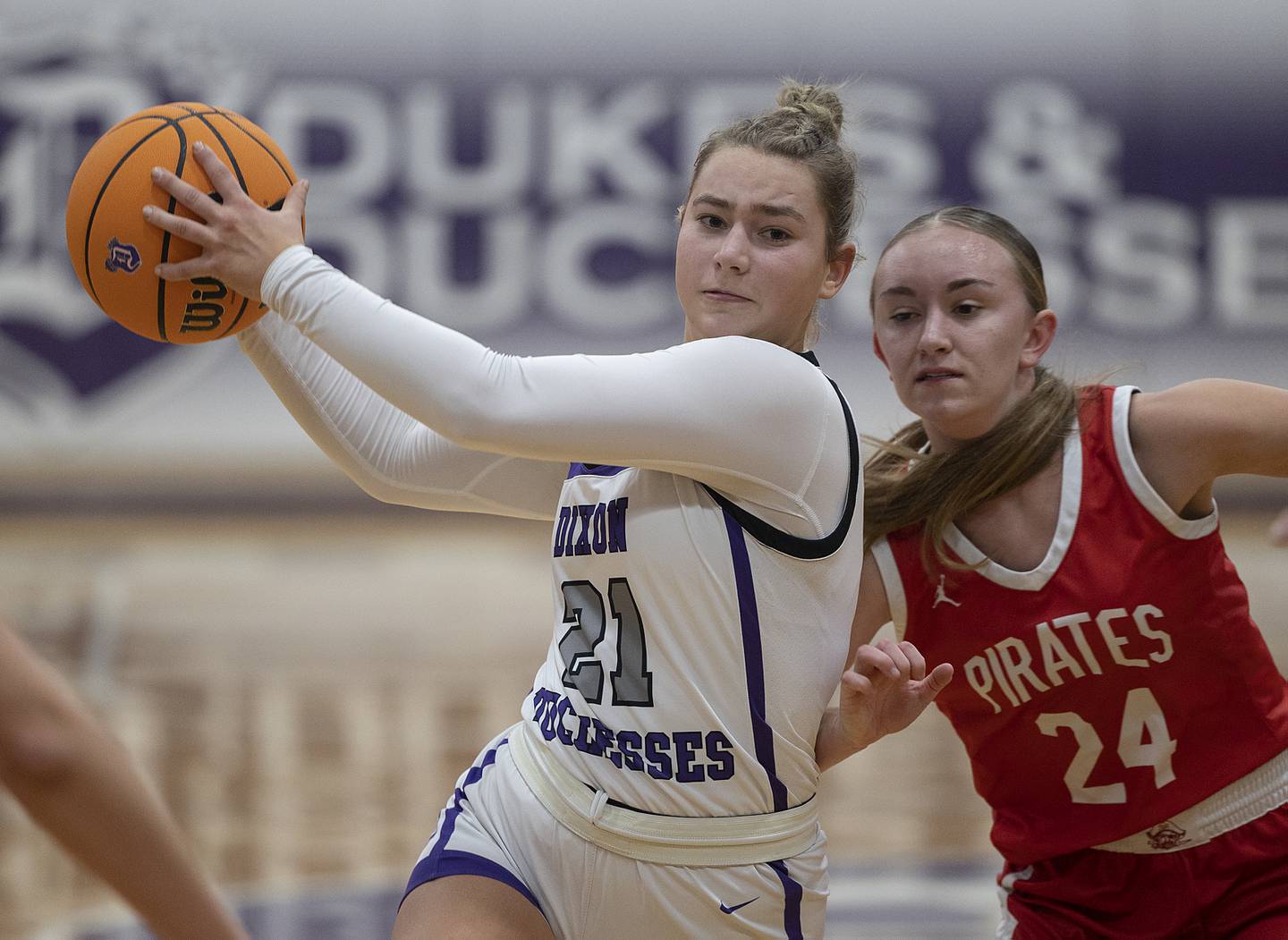 Dixon’s Reese Dambman drives to the lane against Ottawa’s Ashlynn Ganiere Wednesday, Dec. 4, 2024, at Dixon High School.