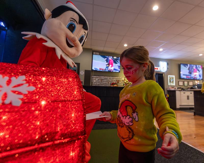 Colette Carls puts letter to Santa into box at the annual Christmas in the Valley on Saturday, November 15, 2025 at the Tee Box in Spring Valley.