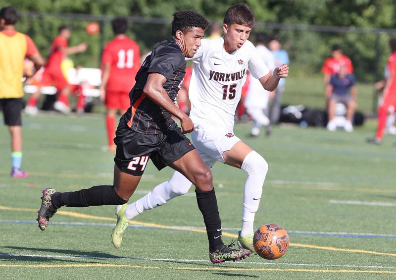 DeKalb's Josiah Antimo tries to sprint ahead of Yorkville's Mizael Terrazas during their game Thursday, Aug. 25, 2022, in the Barb Cup at the Northern Illinois University Outdoor Recreation Sports Complex.