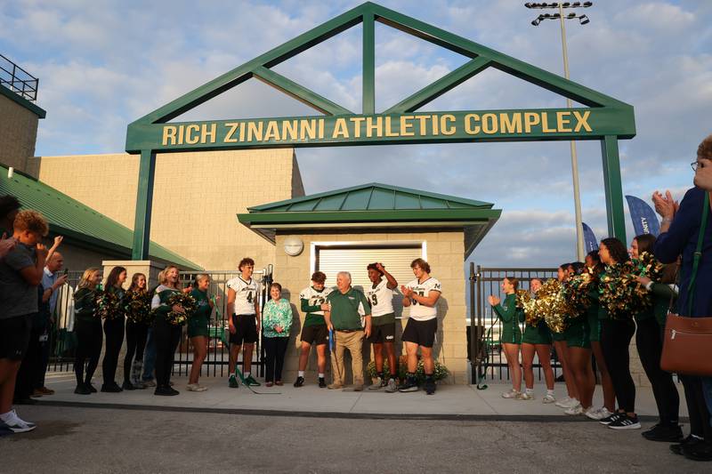 Athletes, alumni and attendees cheer after Rich Zinanni, center, cut the ribbon at Bishop McNamara's new Rich Zinanni Athletic Complex on Thursday, Aug. 21, 2025.