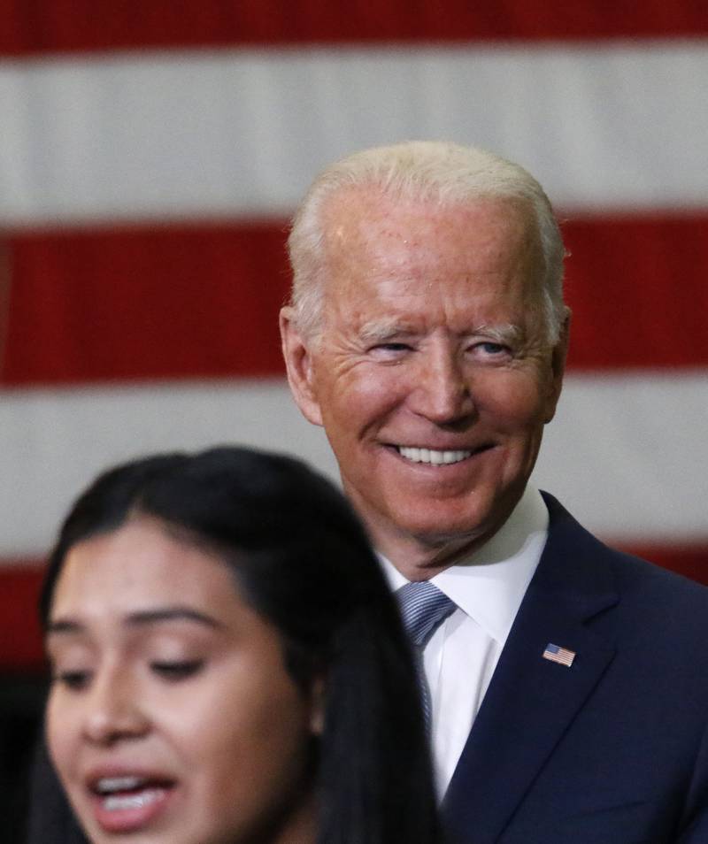 President Joe Biden smiles as McHenry County College student Edith Sanchez of Harvard speaks to attendees during the President's visit to promote his "Build Back Better" campaign at McHenry County College on Wednesday, July 7, 2021 in Crystal Lake.