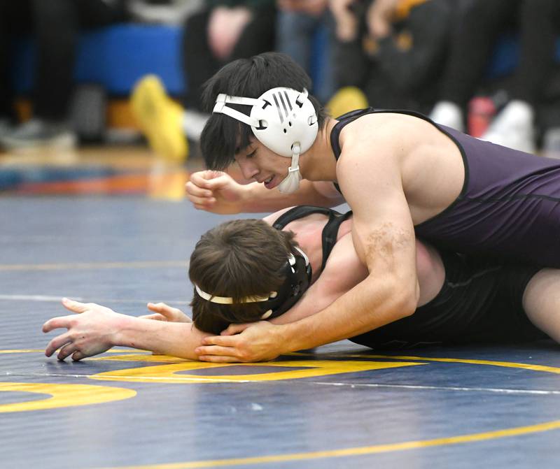 Dixon's Cade Hey (top) wrestles Lena-Winslow's Carson McPeek in the third-place match at 138 pounds at the 1A Polo Wrestling Regional held at Eastland High School in Lanark on Saturday, Feb. 4.