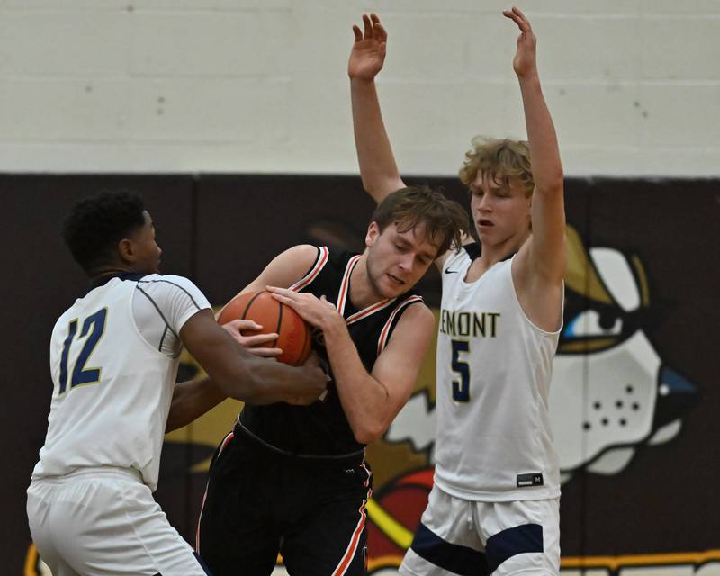 Lemont's Miles Beachum (12) and Minooka's Nick Andreano (22) wrestle for ball possession in the WJOL Basketball Tournament on Monday, November. 21, 2022, at Joliet.