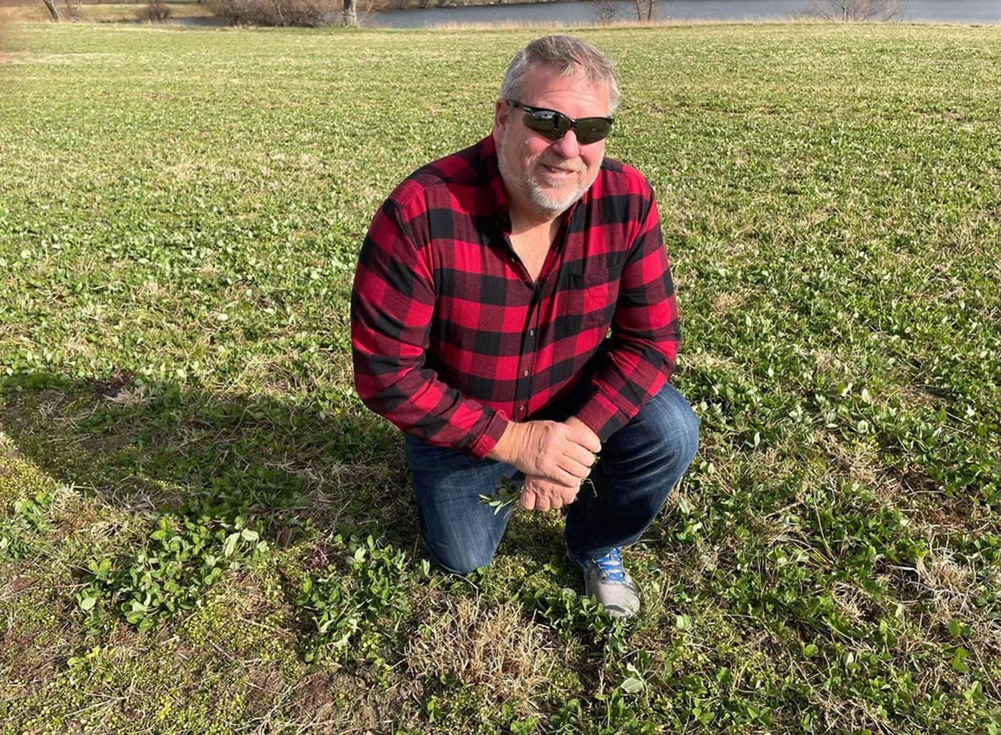 State Rep. Charlie Meier, R-Okawville, shows clover growing in a field on his Washington County farm in 2022. In 2009, Meier was awarded the State of Illinois Conservation Farm Family of the Year.