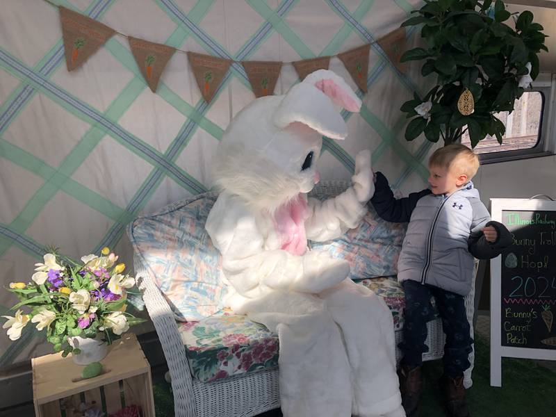 The Easter bunny high-fives Jaxon Frost, 6, of Rockford, at the Illinois Railway Museum March 23, 2024.