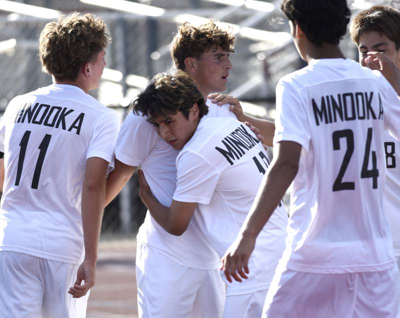 Minooka's Ethan Koranda, center, is embraced by teammates after scoring the first goal in a game against Bradley-Bourbonnias on Tuesday, August 26, 2025.