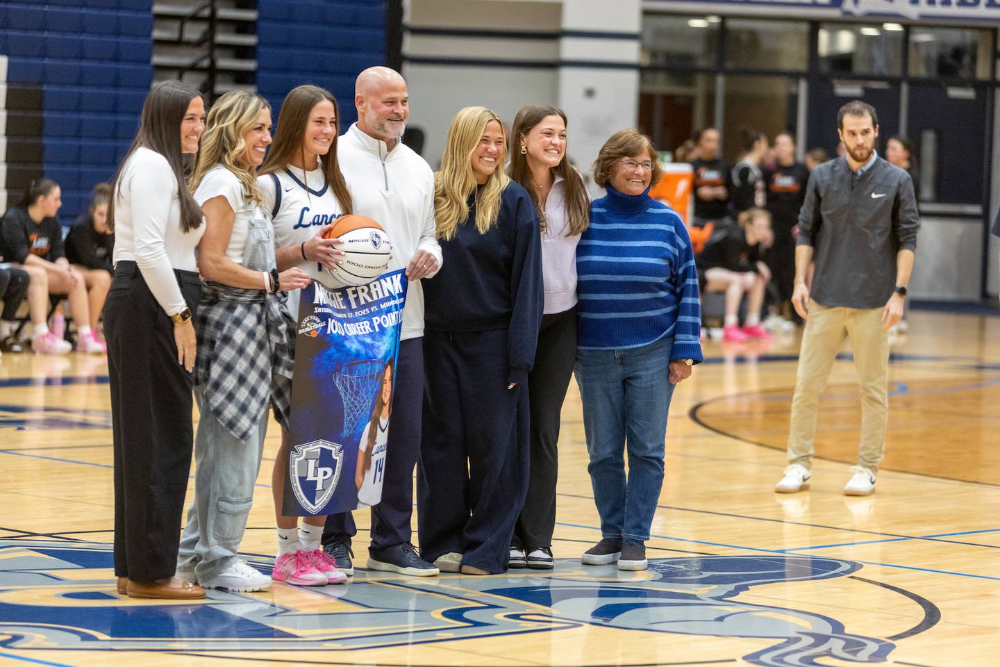 Lake Park's Maggie Frank is honored before the game for scoring 1,000 points with her family on Wednesday, Jan. 7,2026 in Roselle.