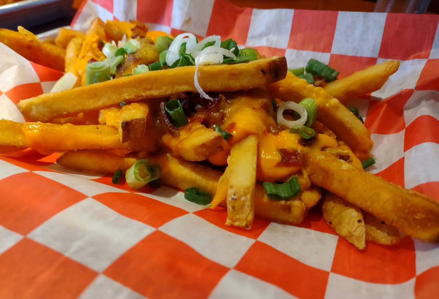 The loaded fries appetizer at No. 4 Social Garage in Seneca is served with three types of cheese, green onion and bacon.