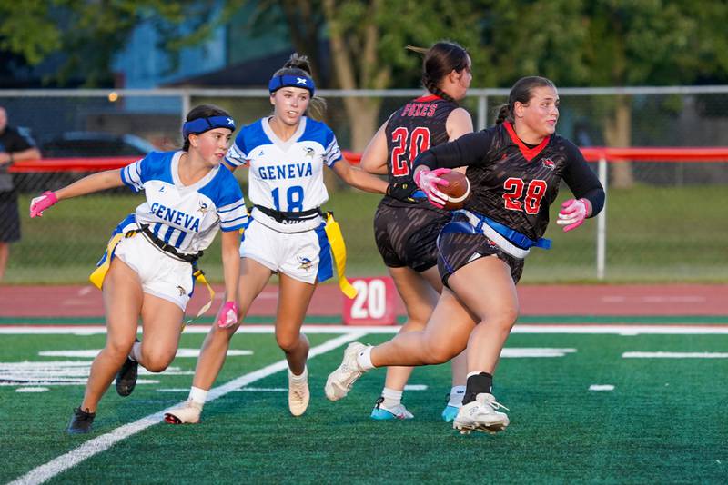 Yorkville's Kayla Kersting (28) runs after the catch for a touchdown against Geneva’s Julia Swierczewski (18) during a non-conference game at Yorkville High School on Tuesday, Sept. 2, 2025.