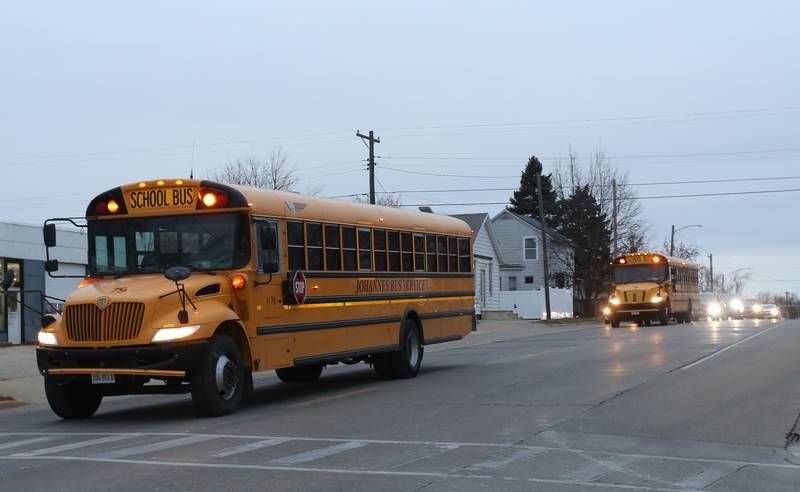 A procession of school busses and parents parade through Spring Valley with the JFK seventh-grade girls basketball team on Thursday, Dec. 12, downtown Spring Valley. The Wildcats will face Mt. Sterling Brown County in the IESA Class 2A State Championship.