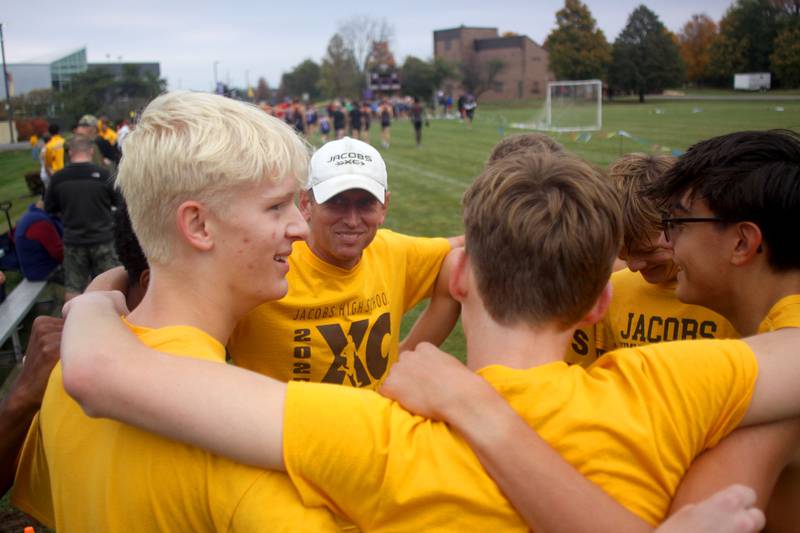 Jacobs’ Golden Eagles gather before the boys race as part of the Fox Valley Conference Cross Country Meet at McHenry County College in Crystal Lake on Saturday, October. 18, 2025.
