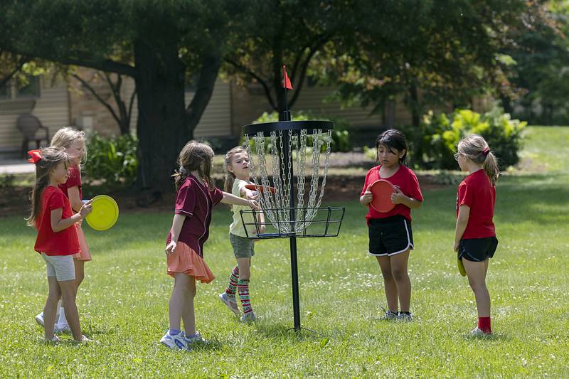 After ice cream, students grab the discs and play some golf Wednesday, May 29, 2024, at St. Anne’s School in Dixon.