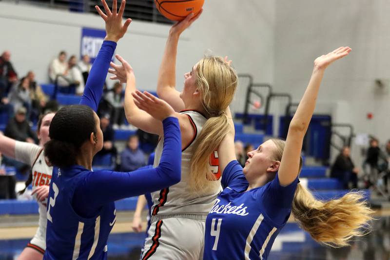 Crystal Lake Central’s Ruby Macke, center, gets past Burlington Central’s Ashley Waslo, right, in IHSA Class 3A Regional Title Game girls basketball action on Thursday, Feb. 20, 2025, at  Central High School in Burlington.