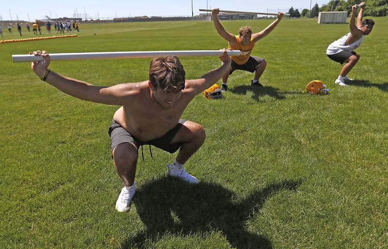 Lineman Kyle Koziel dues equates with his teammates during football practice Monday, June 20, 2022, at Jacobs High School in Algonquin.