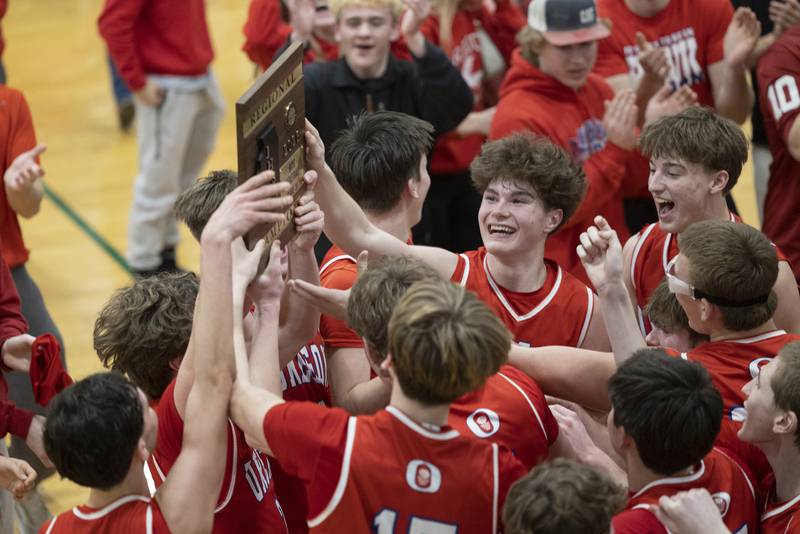 Oregon hoists their regional plaque after defeating Mendota 65-52 Friday, Feb. 27, 2026, at the Class 2A Rock Falls boys basketball regional.