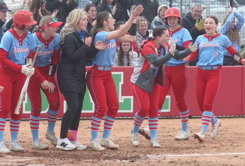 Members of the Ottawa softball team wait to greet teammate Bobbi Snook after hitting a two-run home run against homerun against L-P on Monday, April 21, 2025 at the L-P Athletic Complex in La Salle.