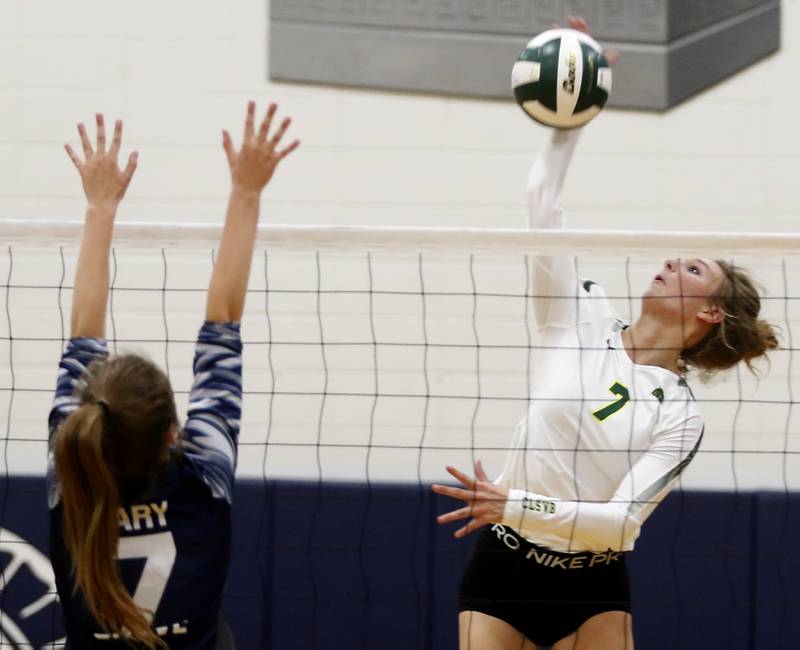 Crystal Lake South’s Gabby Wire, right, hits the ball as Cary-Grove’s Addison DeKett, left, tries to block the ball during a Fox Valley Conference volleyball match Thursday, Aug. 25, 2022, between Cary-Grove and Crystal Lake South at Cary-Grove High School.