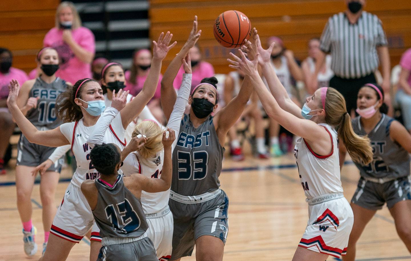 Oswego East's Angela Ruiz (33) fights three West Aurora defenders for a rebound during a basketball game at West Aurora High School on Wednesday, Jan 26, 2022.