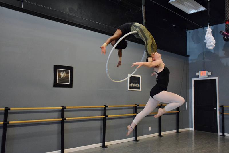 Erika Ellis, top, and Melissa Lerohl, performers with Sycamore Performing Arts Academy’s Artists in Air, practice a routine on the lyra hoop Thursday, May 19, 2022.