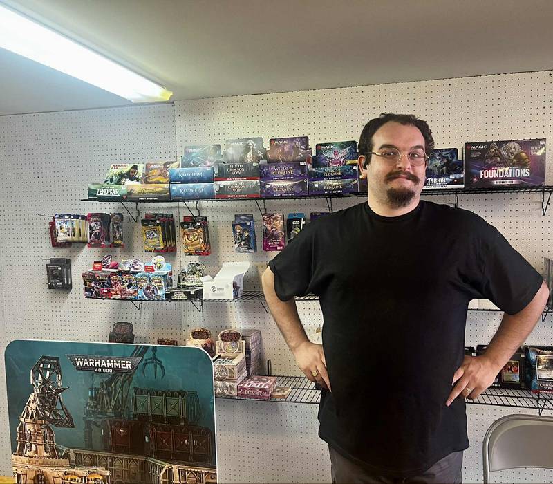 Toby Wright stands behind the counter of his new gaming shop, Azure Dragon Games, in Fulton.