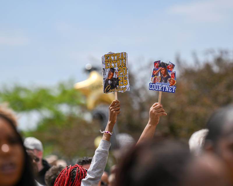 DeKalb High School graduation attendees hold up signs above the crowd on Saturday May 23, 2026, so their graduates can find them better  outside the Convocation Center in DeKalb.