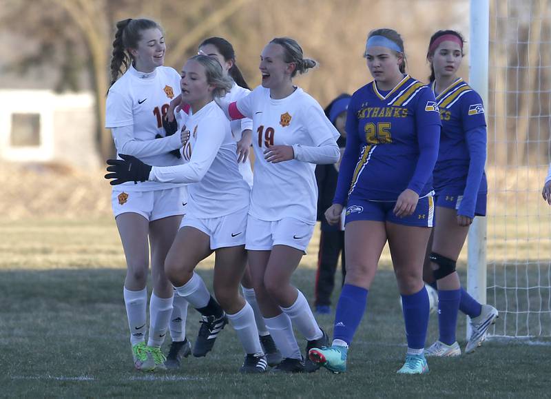 Richmond-Burton’s Madelyn Seyller (center) is mobbed by here teammates after scoring the winning goal during a Kishwaukee River Conference soccer game against Johnsburg on Wednesday, March 20, 2024, at Johnsburg High School.