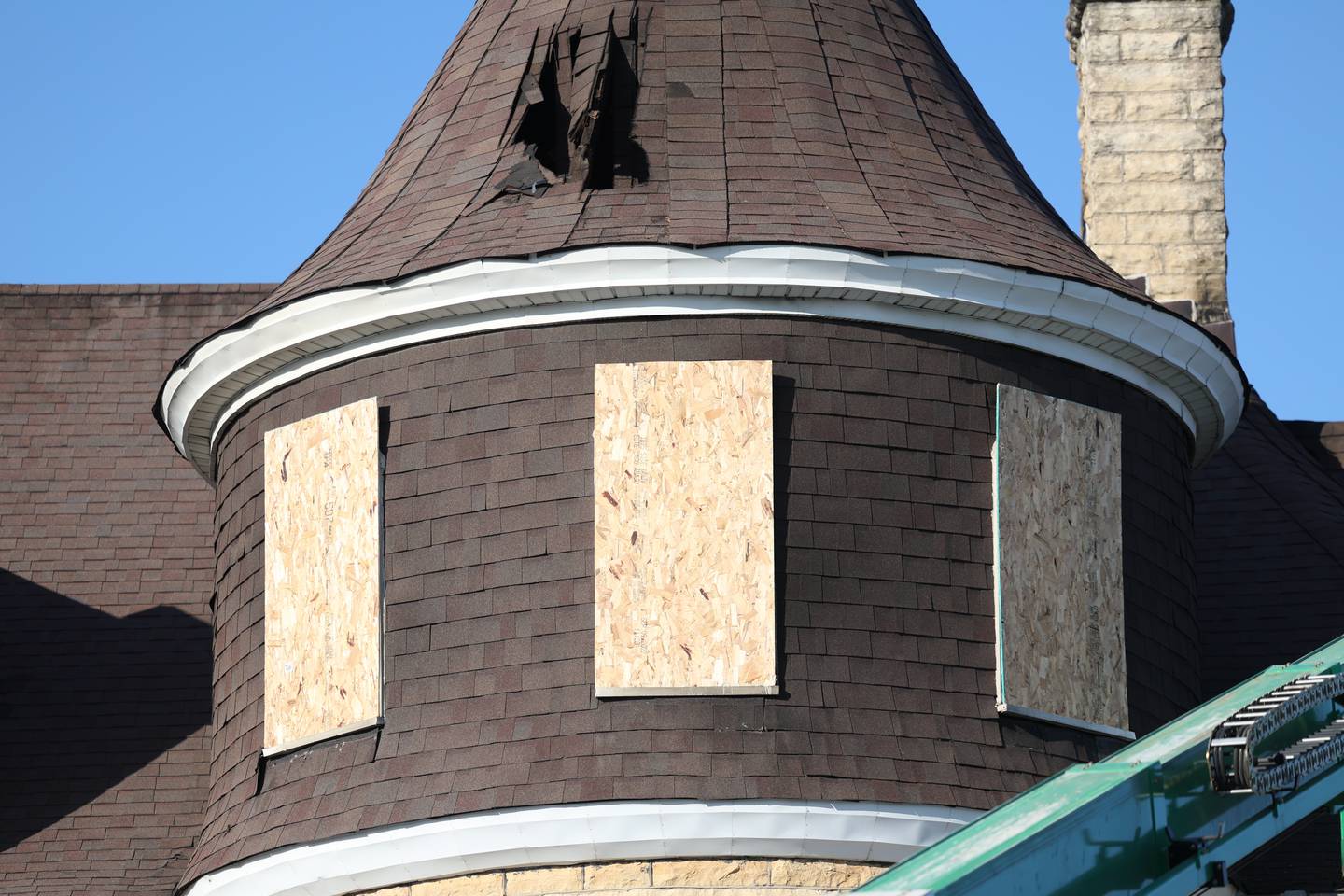 Windows are boarded up that was damaged by a fire at the Haley Mansion on Wednesday evening.