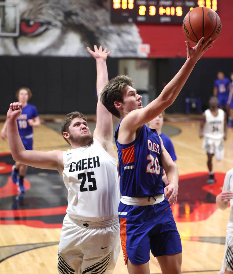 Genoa-Kingston's Nathan Skarzynski shoots a layup in front of Indian Creek's Jake Taylor Wednesday, Jan. 25, 2023, during their game at Indian Creek High School in Shabbona.