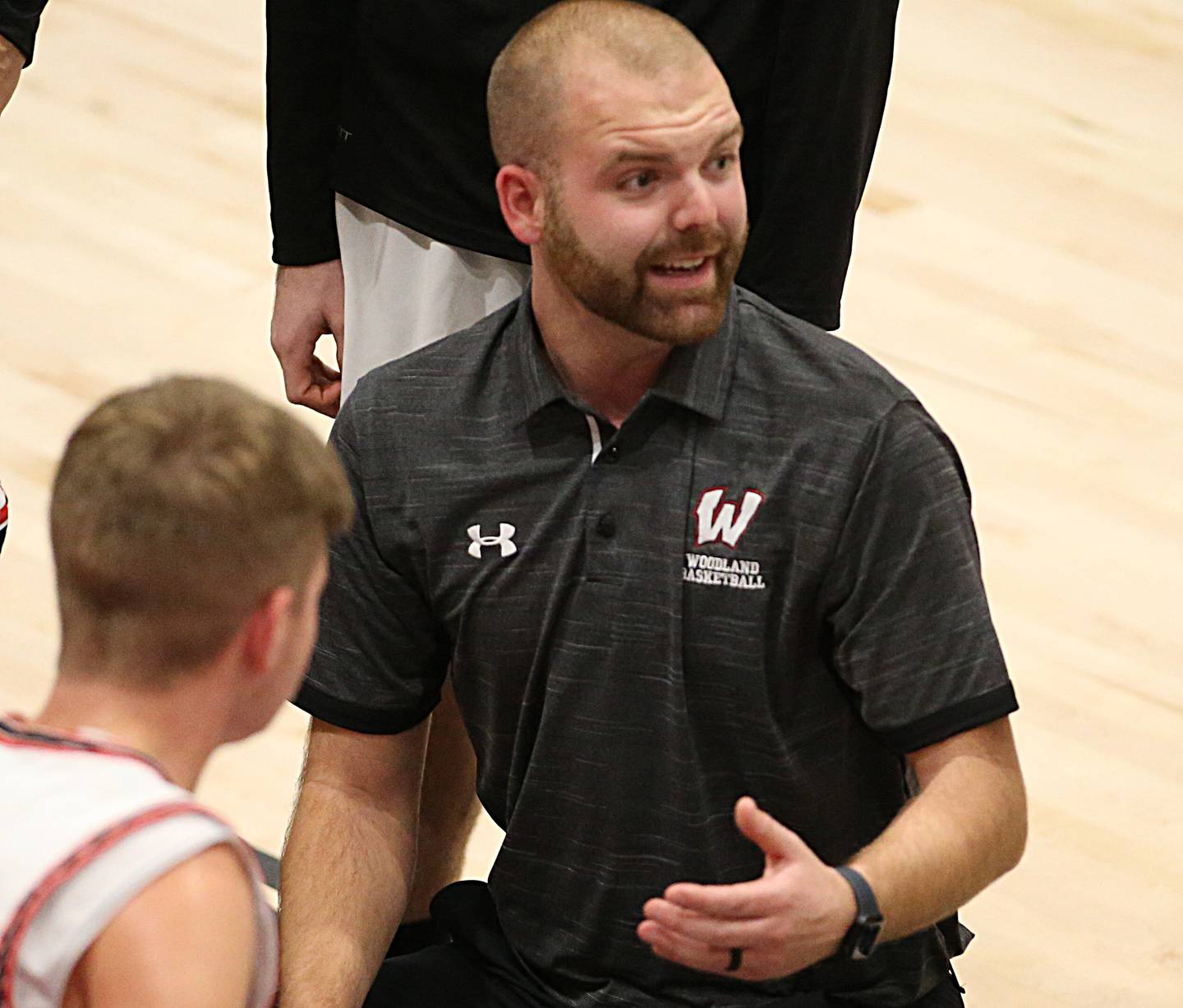 Woodland head boys basketball coach Connor Kaminke talks to his team during a timeout Tuesday, Nov. 22, 2022, at the Warrior Dome.