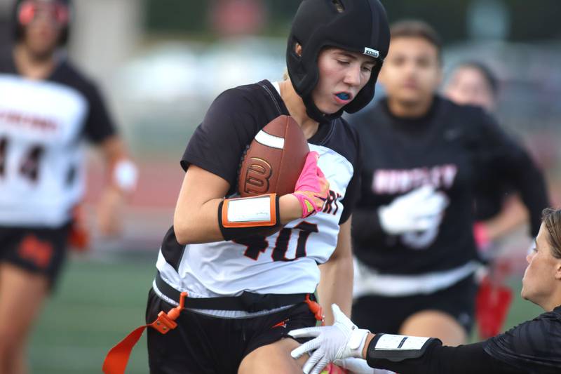 McHenry’s Hailey Weigelt carries the ball in varsity flag football at Huntley High School in Huntley on Tuesday, Sept. 9, 2025.