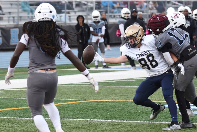 Lemont's Michael Kalkowski (88) has a would-be reception deflect off his hands before it was intercepted by Kankakee's Zion Thomas, left, during an IHSA Class 5A playoff game at Kankakee Saturday, Nov. 1, 2025.