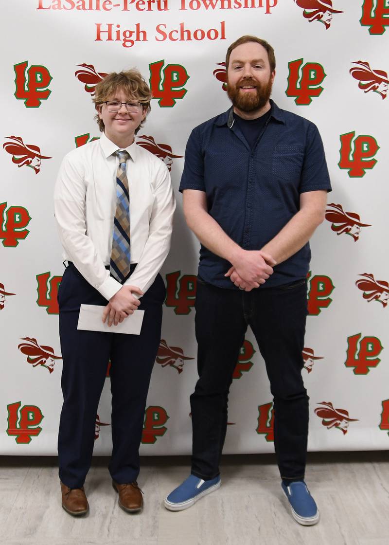 Kaden Dellinger (left) received the Quesse Technology Scholarship, presented by Billy Quesse (right). The $1,000 scholarship is awarded to a student who plans to pursue a career in a field related to computer technology.