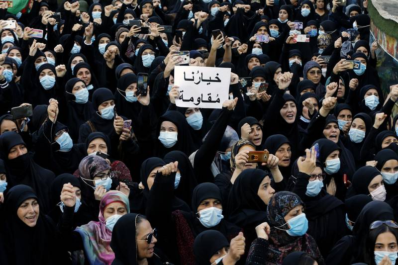 FILE – In this Oct. 15, 2021, mourners chant slogans as they hold a placard with Arabic that reads "Our choice is resistance" during the funeral of three Hezbollah supporters who were killed during clashes, in the southern Beirut suburb of Dahiyeh, Lebanon. Internal company documents from the former Facebook product manager-turned-whistleblower Frances Haugen show that in some of the world's most volatile regions, terrorist content and hate speech proliferate because the company remains short on moderators who speak local languages and understand cultural contexts. (AP Photo/Bilal Hussein, File)