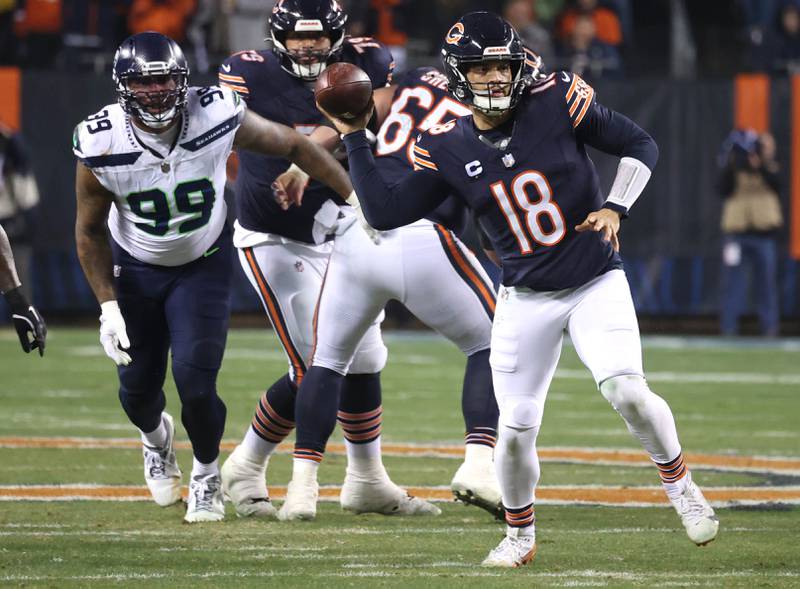 Chicago Bears quarterback Caleb Williams sidearms a pass after escaping the Seattle Seahawks pass rush during their game Sunday, Dec. 26, 2024, at Soldier Field in Chicago.