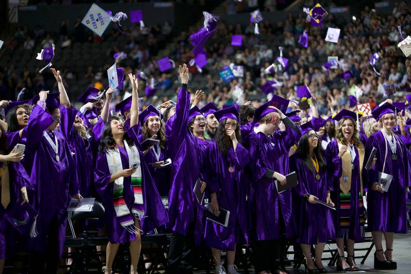 Students toss their caps after graduating at Hampshire High School graduation ceremony on May 21, 2022, at the NOW Arena in Hoffman Estates.
