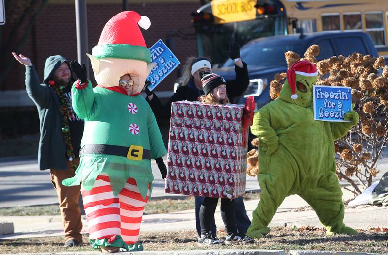 Volunteers dress in Holiday costume apparel for the annual Freezin' for a Reezin' event on Friday, Dec. 6, at the corner of La Salle and Lafayette Street downtown Ottawa. The all-day event to helps the Ottawa Community Food Basket.