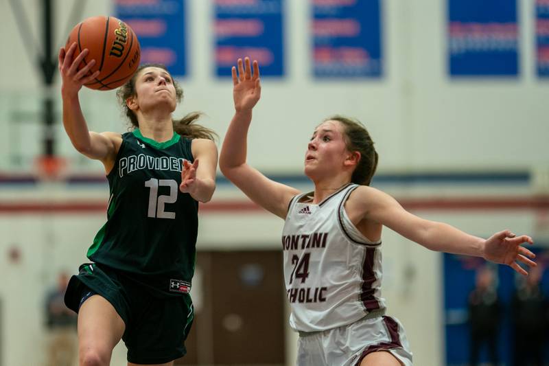 Providence's Bella Morey (12) drives to the hoop against Montini’s Peyton Farrell (24) during the 3A Glenbard South Sectional basketball final at Glenbard South High School in Glen Ellyn on Thursday, Feb 23, 2023.