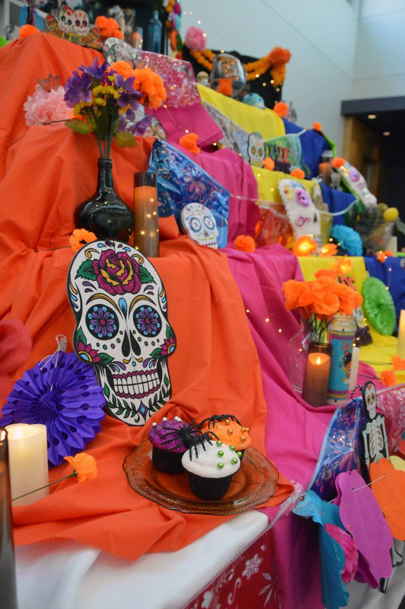 Students and employees stop in IVCC’s main atrium to admire the symbolic displays and personal tributes that make an eye-catching Day of the Dead altar.