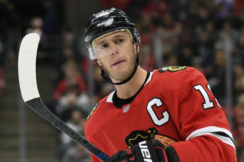 FILE - Chicago Blackhawks center Jonathan Toews (19) plays against the Buffalo Sabres during the first period of an NHL hockey game in Chicago, in this Sunday, Nov. 17, 2019, file photo. Chicago Blackhawks captain Jonathan Toews will miss the start of training camp due to an illness, and there is no timetable for his return. The 32-year-old Toews said Tuesday, Dec. 29, 2020, he has been experiencing symptoms that have left him feeling “drained and lethargic.” (AP Photo/David Banks, File)