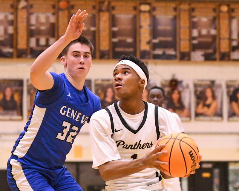 Glenbard North's Lamari Carpenter (1) gets fouled by Geneva's Benjamin Peterson (32) during the game on Tuesday Jan. 6, 2025, held at Glenbard North High School.