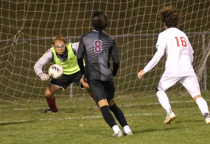 Ottawa keeper Laundry Brenbarger eyes the ball as Kankakee's Maddox Mathews and Ottawa's Ian Fulkerson watch the play during the Class 2A Regional semifinal game on Monday, Oct. 20, 2025 at Ottawa HIgh School.