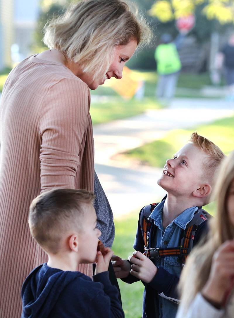 Stephanie Bradac says goodbye to her son Finn as he prepares to start first grade Tuesday, Aug. 16, 2022, on opening day at Genoa Elementary School.