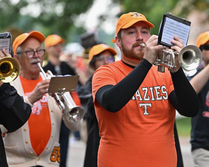 Crystal Lake Central High School's alumni join the school's Marching Tiger Band to begin the start of the school's 100 year anniversary homecoming day parade on Saturday, Sep. 16, 2023 in Crystal Lake. The parade began at the high school and made its way through downtown Crystal Lake.