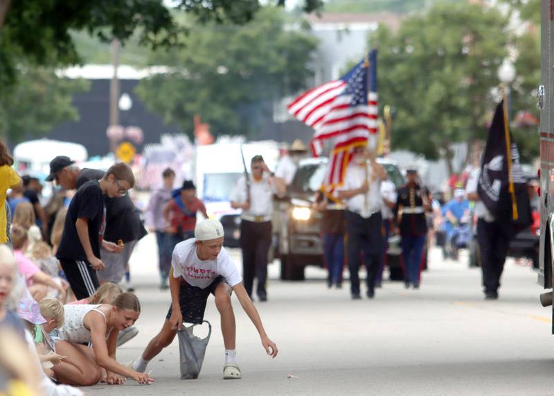 Kids gather candy as the Fiesta Days Parade makes its way down Main Street in McHenry on Sunday, July 20, 2025.