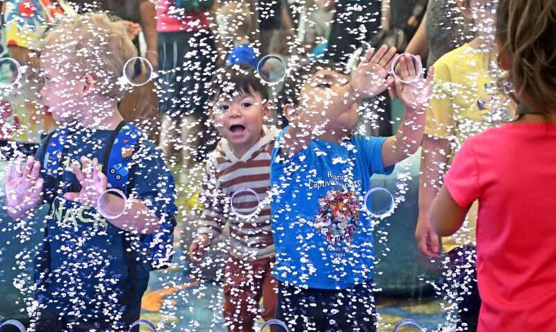 Kids enjoy 15-foot tall bubble wall at the Gail Borden Library' newly imagined KidSpace on Tuesday in Elgin.
